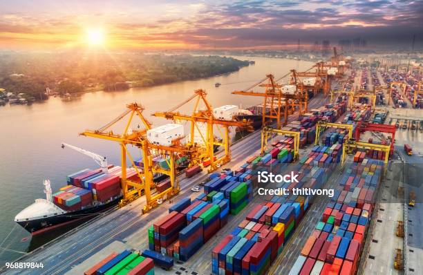 Logistics And Transportation Of Container Cargo Ship And Cargo Plane With Working Crane Bridge In Shipyard At Sunrise Logistic Import Export And Transport Industry Background Stock Photo - Download Image Now