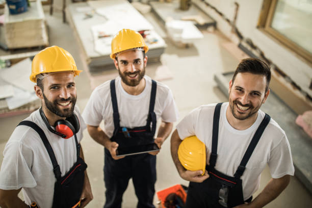 istock Above view of happy manual workers at construction site. 968823162