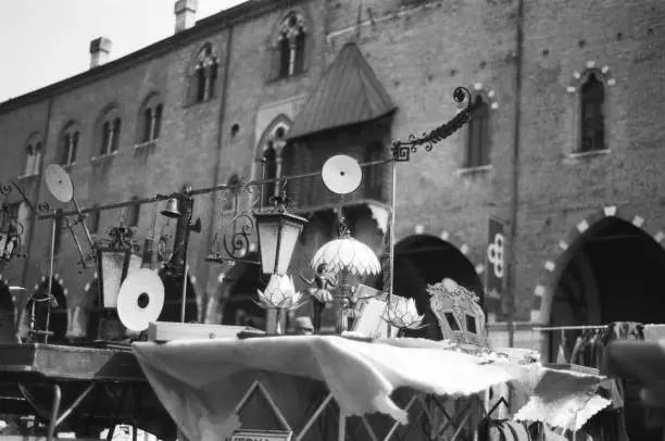 Vintage lamps on the flea market on windy day in piazza Sordello, Mantua.