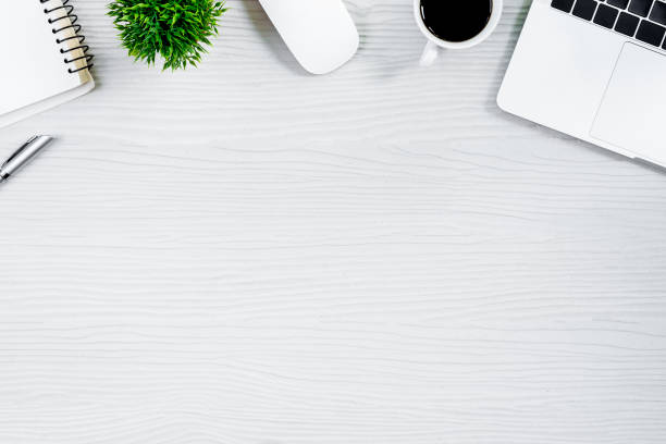 istock White wood office desk table and equipment for working with black coffee  in top view and flat ray concept. 968831134