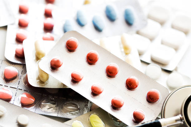 Stethoscope, medicine and pills close up