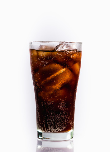 Glass of soft drink with reflection on white background.