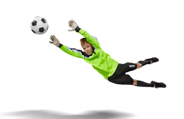 goalkeeper kid jumping for the ball isolated on white