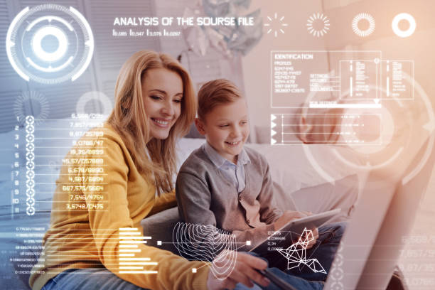 istock Diligent pupil doing homework in his gadget and a smiling mother helping 968841134