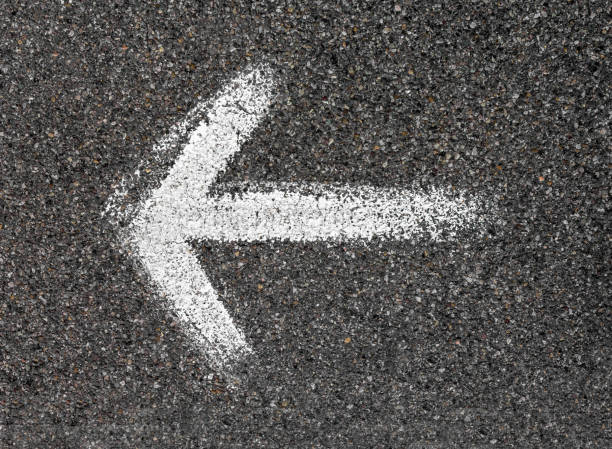 istock White arrow painted on the road 968841254