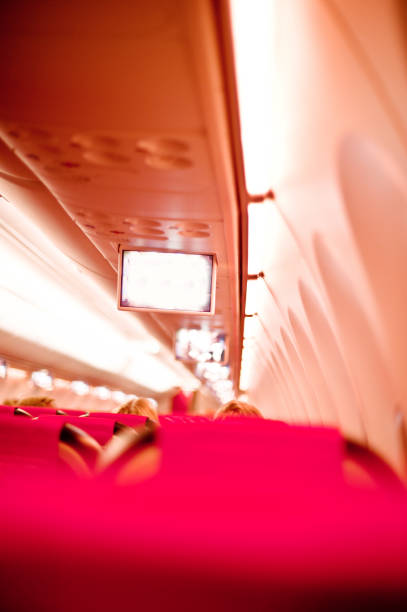 istock Aeroplane Cabin Mid-Air With In-Flight Entertainment System 968845190