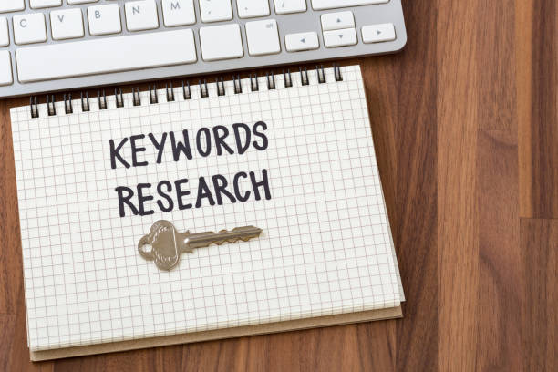 istock Keywords research on wooden table background 968846408