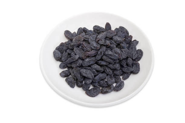 istock Raisins on the saucer on a white background 968846582