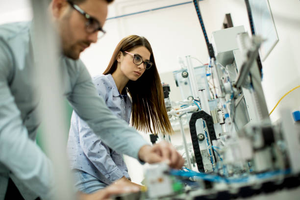 istock Young couple of students working at robotics lab 968849122