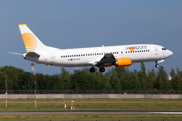 9H-ZAZ Air Horizont Boeing 737-400 aircraft on the blue sky background stock photo