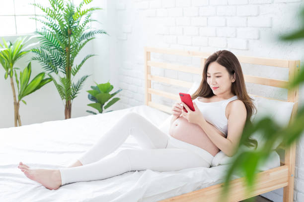 istock pregnant women use phone happily 968849844
