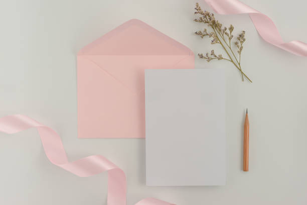 istock A wedding mock up concept. Wedding Invitation, envelopes, cards Papers on white background with ribbon and decoration. Top view, flat lay, copy space 968852590