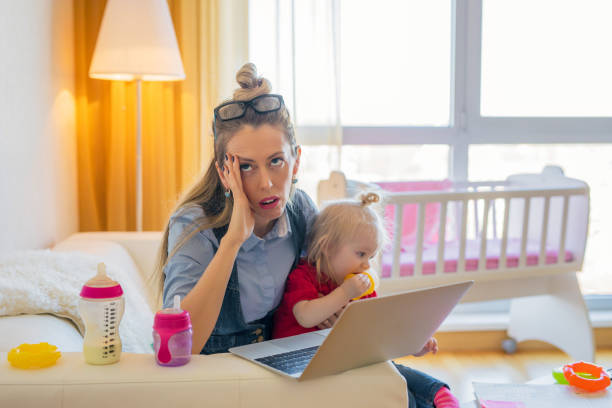 istock Exhausted woman with little child 968853050