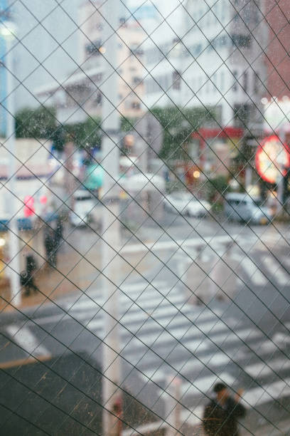 istock Rain drop on a window, outside is a people and city, Japan 968853480