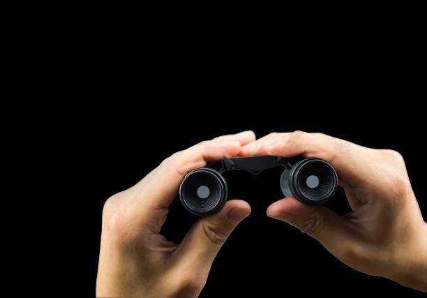 istock Binocular on hand holding isolated on black background with clipping path 968855684