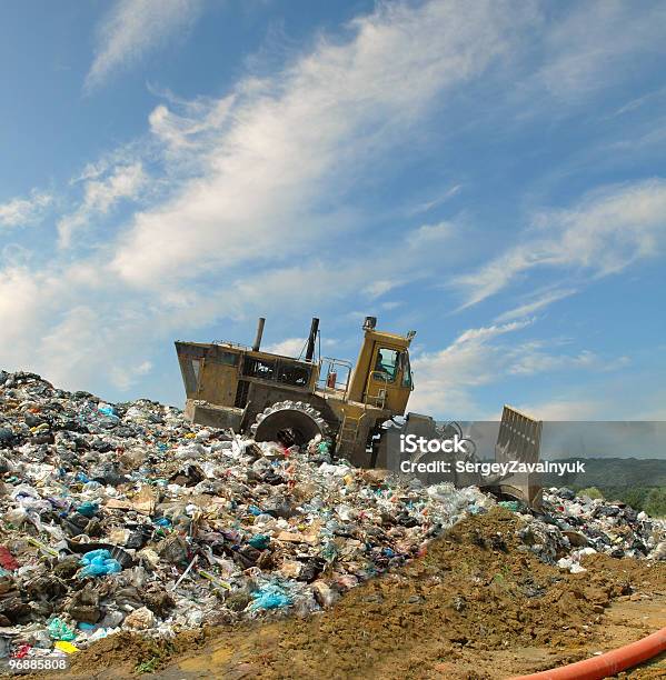 The Bulldozer On A Garbage Dump Stock Photo - Download Image Now - Bulldozer, Buried, Burying