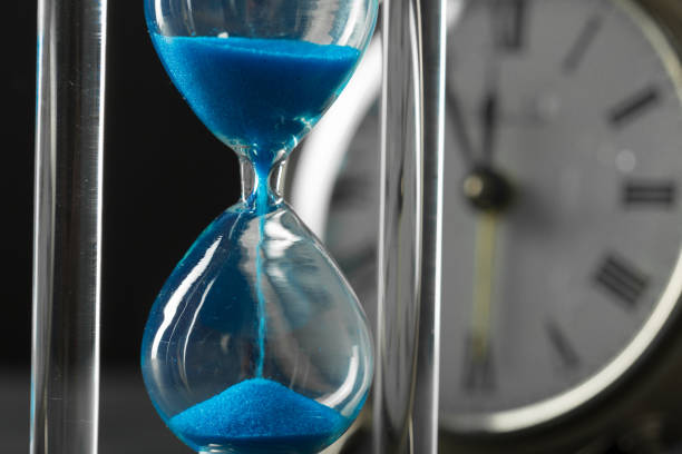 istock Time is passing. Blue hourglass close up 968860604