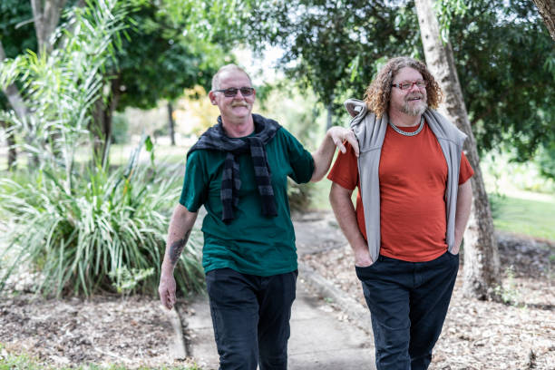 istock Middle Aged Gay Men Relaxing Walking Together 968863270