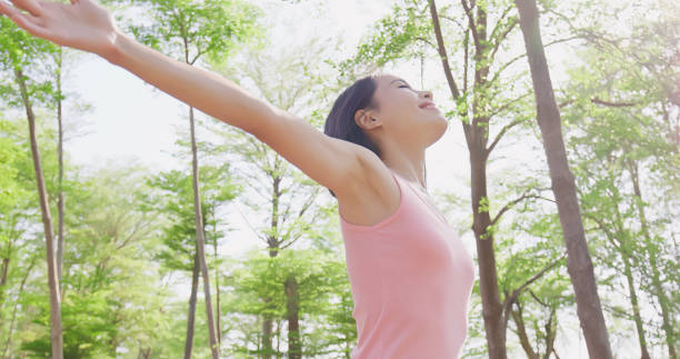 istock woman feel free in forest 968863286
