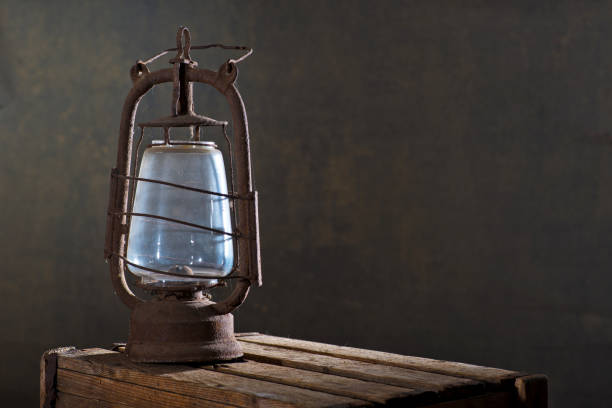 istock Old Rusty Lantern on the Wooden Desk in the Attic 968866588