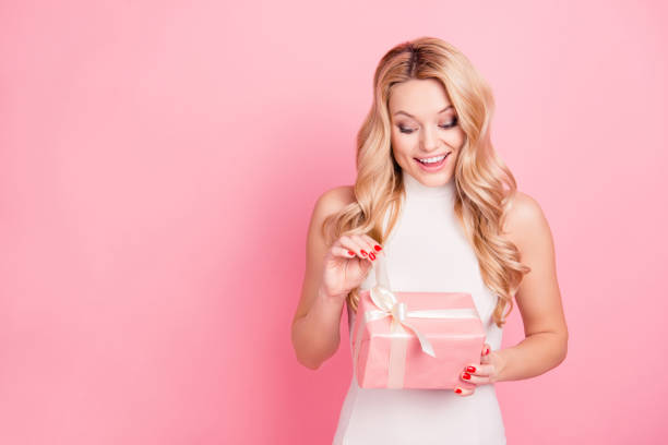 istock Portrait with copyspace, empty place of pretty charming elegant girlfriend celebrating 8-march, valentine day, opening packed gift box isolated on pink background 968866948
