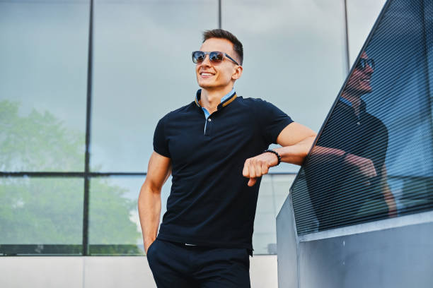 istock Stylish male in sunglasses over modern building background. 968867352