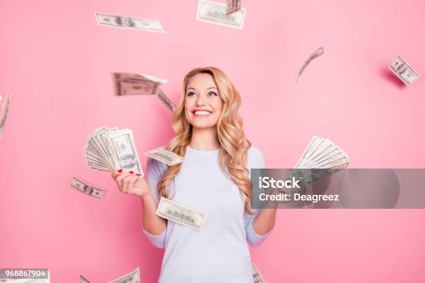 Portrait Of Pretty Charming Positive Cute Successful Lucky Cheerful Girl Standing Under Shower From Money Having A Lot Of Money In Hands Isolated On Pink Background Stock Photo - Download Image Now
