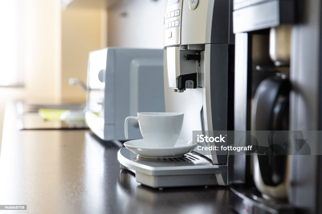 Mug stands in a coffee machine Cup of espresso from a coffee machine Coffee Maker Stock Photo