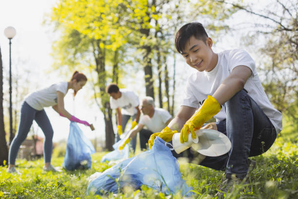 istock Attractive male volunteer picking litter 968872186