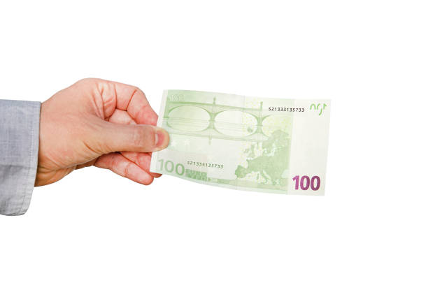 istock Money Euro in a hand isolated on white 968874946