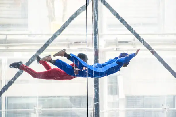 Photo of Skydivers in indoor wind tunnel, free fall simulator