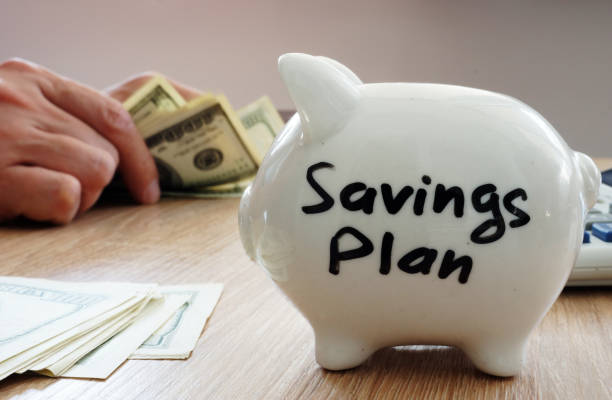 istock Savings Plan. Piggy bank and hands counting money. 968886884