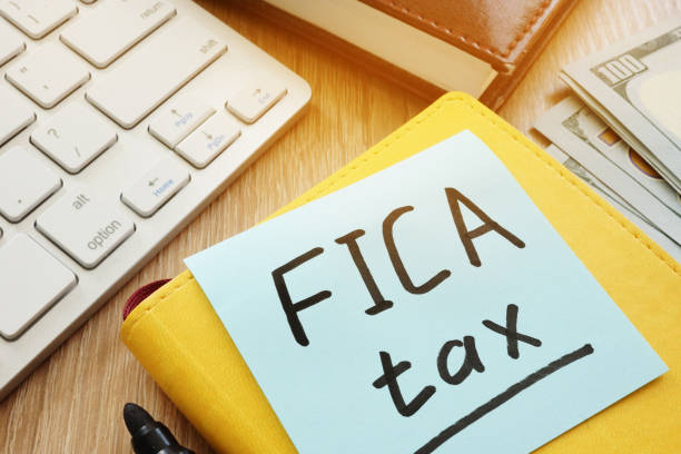 istock Stick with words fica tax and keyboard. 968894172