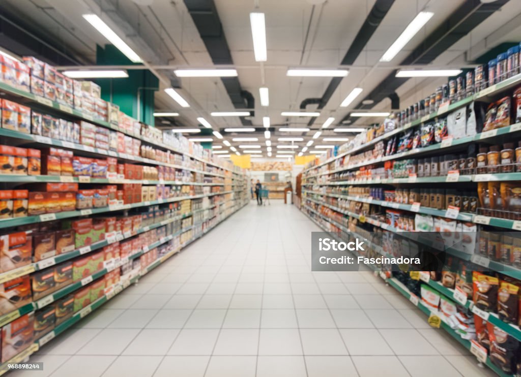 blurred supermarket aisle Abstract blurred supermarket aisle with colorful shelves and unrecognizable customers as background Supermarket Stock Photo