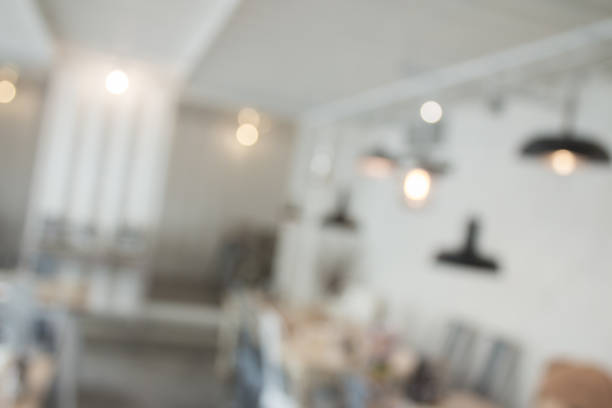 istock Blurred interior design with bright white lighting and hanging lights in cafe or restaurant. 968898266