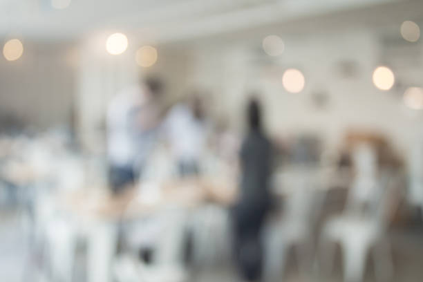 istock Blurred interior design with bright white lighting and hanging lights in cafe or restaurant. 968898294