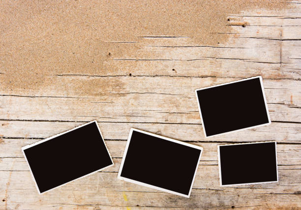 istock Sand and photographs on planked wood. Summer background with copy space. Top view 968898830