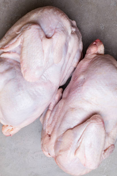 istock two fresh, raw bio chicken on grey background. Top view. Diet food 968901732