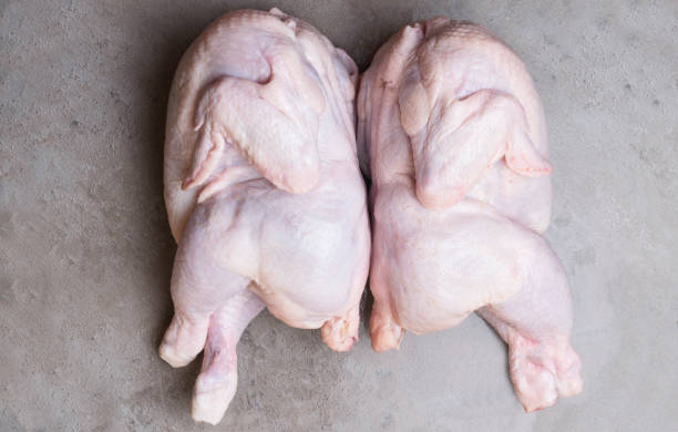 istock two fresh, raw bio chicken on grey background. Top view. Diet food 968901942