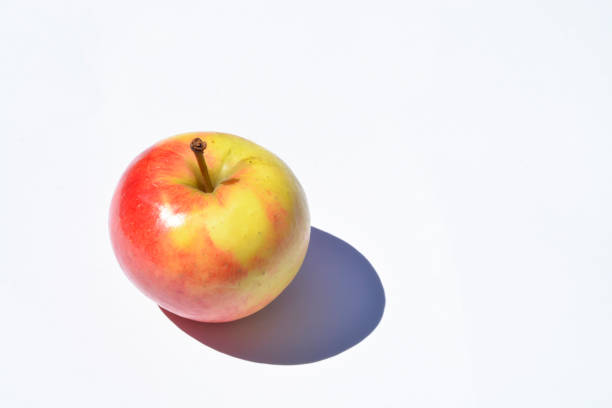 Fresh apples on a wooden table on the background of a mountain landscape.