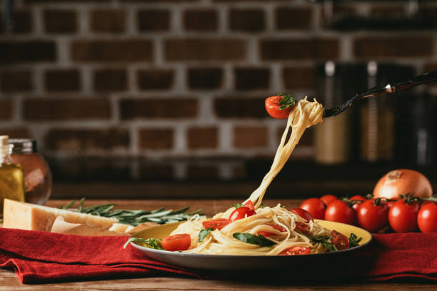 istock traditional italian pasta with tomatoes and arugula on fork 968903980