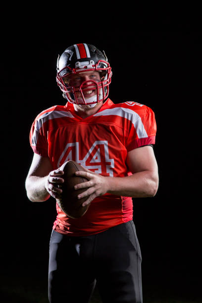istock Football player portrait on black background 968910844