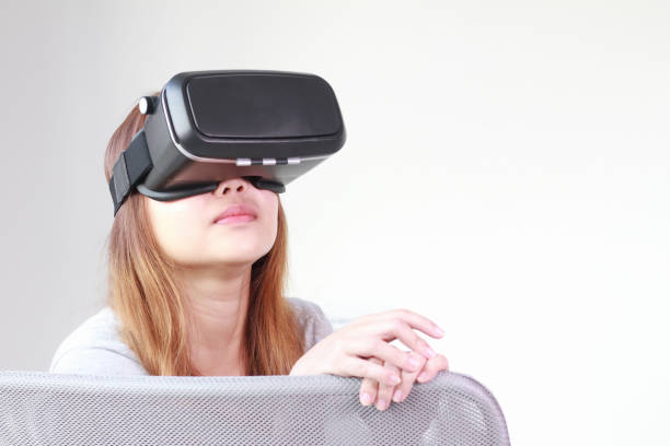 istock Young woman wearing virtual reality glasses at home. 968910908