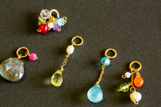 istock lemon quartz, ruby, pearl,labradorite,apatite, green chalcedony, blue topaz necklace charm isolated on black background. 968911020