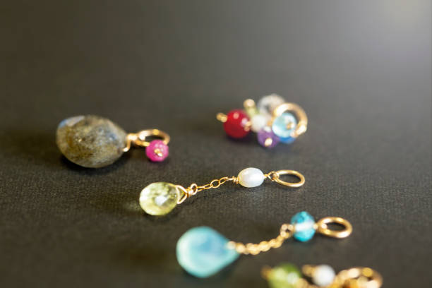 istock lemon quartz, ruby, pearl,labradorite,apatite, green chalcedony, blue topaz necklace charm isolated on black background. 968911128