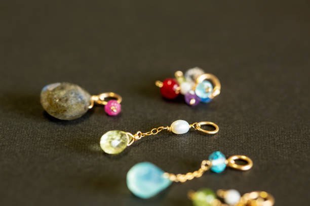 istock lemon quartz, ruby, pearl,labradorite,apatite, green chalcedony, blue topaz necklace charm isolated on black background. 968911160