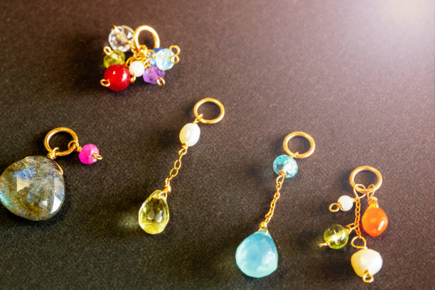 istock lemon quartz, ruby, pearl,labradorite,apatite, green chalcedony, blue topaz necklace charm isolated on black background. 968911208