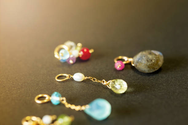 istock lemon quartz, ruby, pearl,labradorite,apatite, green chalcedony, blue topaz necklace charm isolated on black background. 968911274