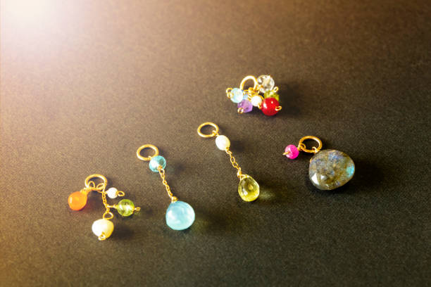 istock lemon quartz, ruby, pearl,labradorite,apatite, green chalcedony, blue topaz necklace charm isolated on black background. 968911306