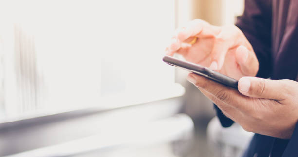 istock Businessman asian using phone for celling and texting on her mobile phone 968913586